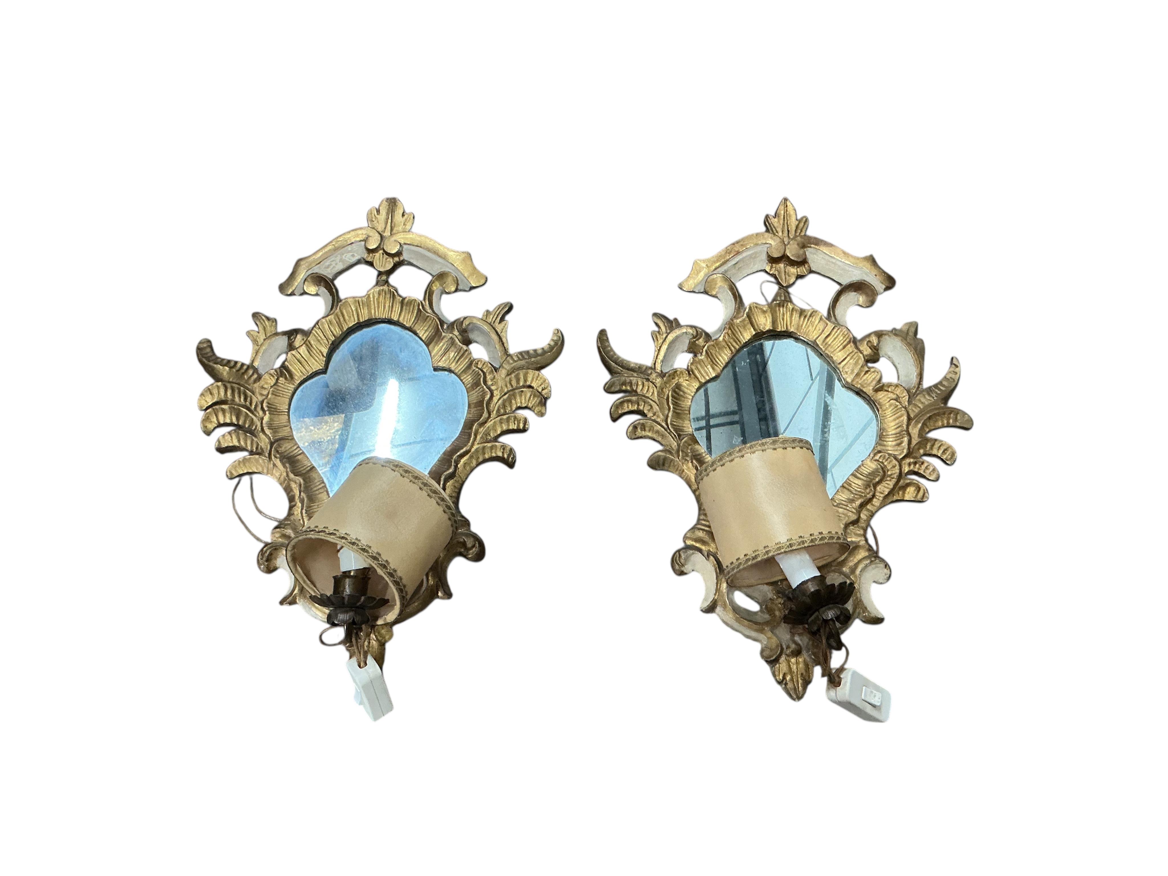 A pair of Italian parcel gilt framed Rococo Revival single light girandole wall mirrors, width 36cm, height 48cm